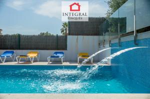 The pool is large and has two small waterfalls that create a relaxing atmosphere.